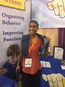 student showing off the weighted vest
